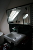 Badschrank , schwarz glänzend, Spiegel mit Facette